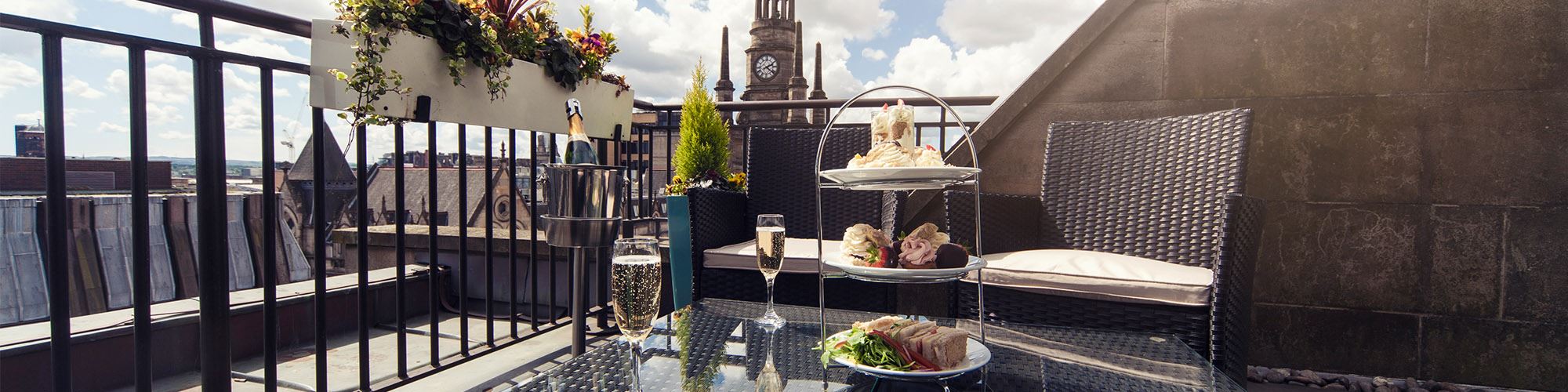 Afternoon tea with prosecco served on a rooftop balcony